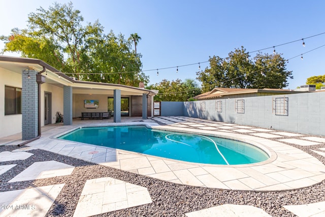 view of swimming pool featuring a patio area