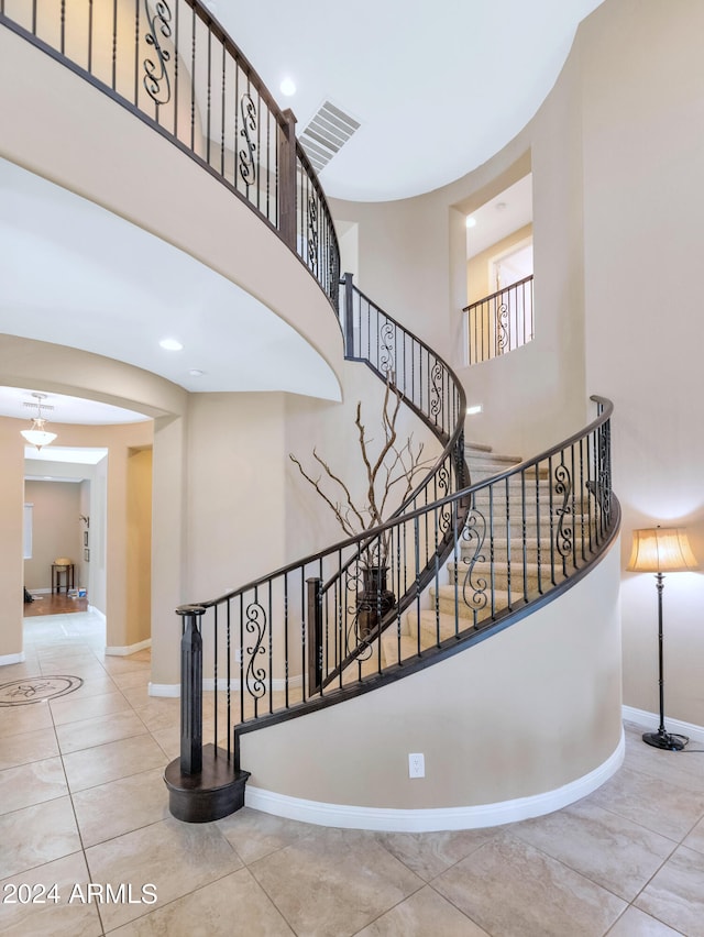 stairs featuring a towering ceiling