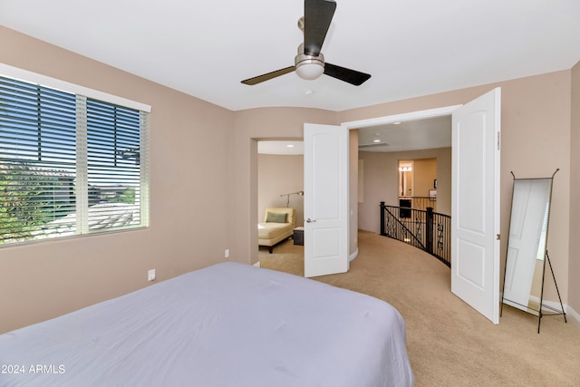 bedroom featuring light carpet and ceiling fan