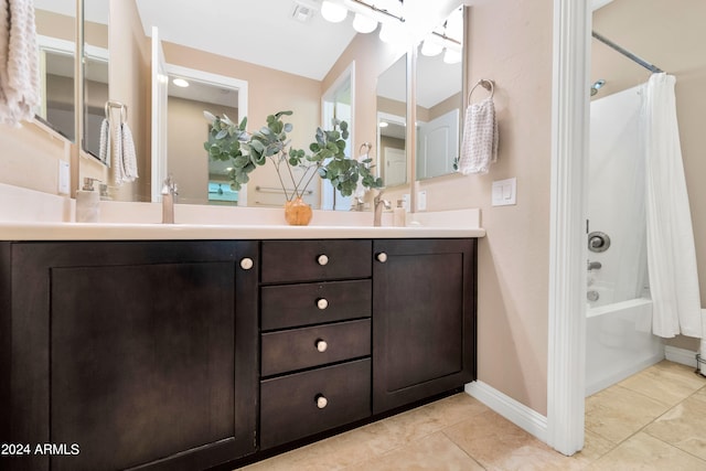 bathroom featuring tile patterned floors, shower / tub combo, and vanity