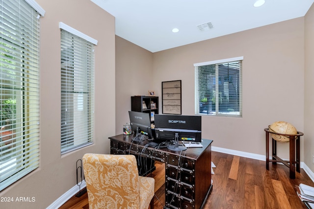 office featuring a wealth of natural light and dark hardwood / wood-style flooring