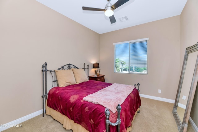 bedroom featuring light colored carpet and ceiling fan