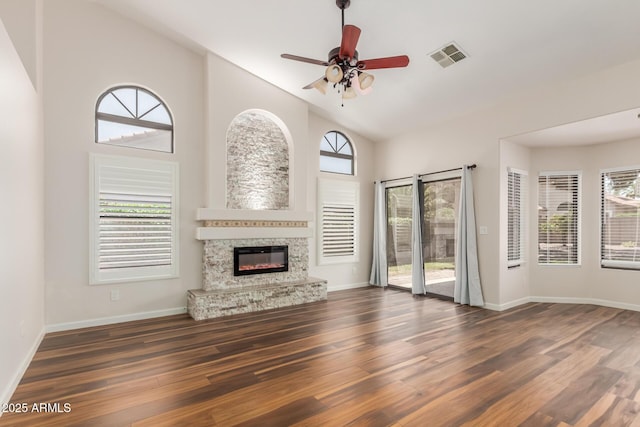 869 W Emerald Island Dr, Gilbert, AZ 85233 - unfurnished living room featuring wood finished floors, ceiling fan, a glass covered fireplace, baseboards, and high vaulted ceiling