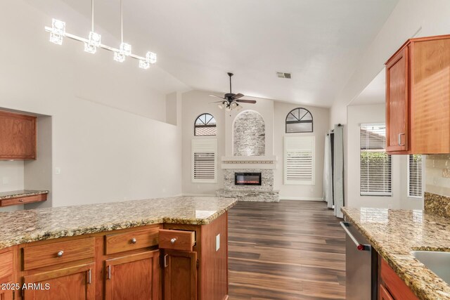 869 W Emerald Island Dr, Gilbert, AZ 85233 - kitchen featuring a ceiling fan, dishwasher, lofted ceiling, dark wood-style flooring, and a glass covered fireplace