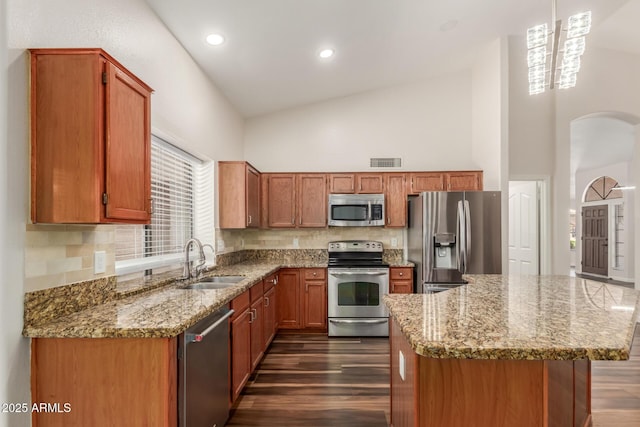 869 W Emerald Island Dr, Gilbert, AZ 85233 - kitchen featuring stainless steel appliances, a sink, high vaulted ceiling, dark wood-type flooring, and light stone counters