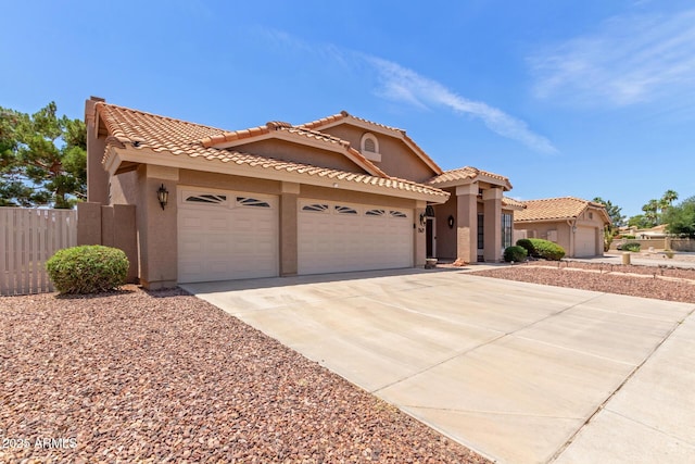 869 W Emerald Island Dr, Gilbert, AZ 85233 - mediterranean / spanish-style home with stucco siding, an attached garage, driveway, and a tile roof