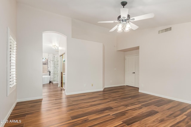 869 W Emerald Island Dr, Gilbert, AZ 85233 - unfurnished room with arched walkways, wood finished floors, a ceiling fan, baseboards, and vaulted ceiling