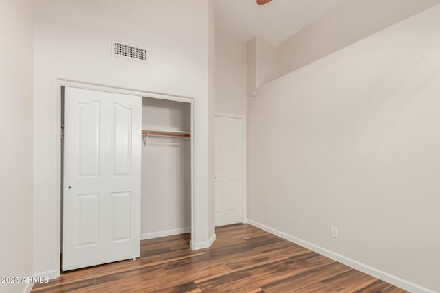 869 W Emerald Island Dr, Gilbert, AZ 85233 - unfurnished bedroom with wood finished floors, baseboards, a closet, and high vaulted ceiling