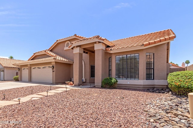 869 W Emerald Island Dr, Gilbert, AZ 85233 - mediterranean / spanish-style house with stucco siding, an attached garage, a tiled roof, and driveway