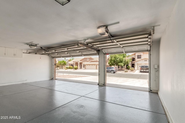 869 W Emerald Island Dr, Gilbert, AZ 85233 - garage with a garage door opener and baseboards