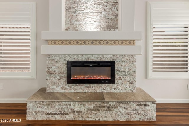 869 W Emerald Island Dr, Gilbert, AZ 85233 - detailed view of a glass covered fireplace, wood finished floors, and baseboards