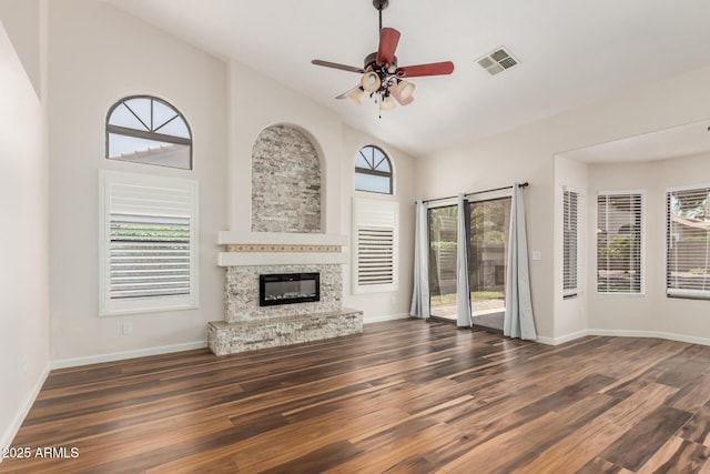 869 W Emerald Island Dr, Gilbert, AZ 85233 - unfurnished living room featuring wood finished floors, ceiling fan, a glass covered fireplace, baseboards, and high vaulted ceiling