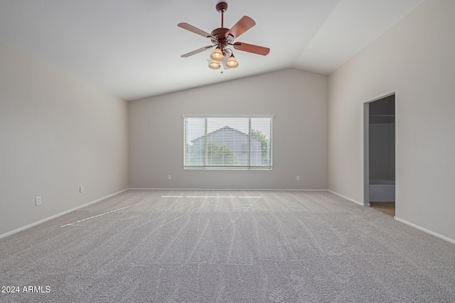 unfurnished room featuring ceiling fan, lofted ceiling, and light carpet