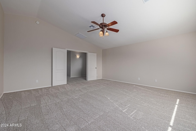 unfurnished bedroom with ceiling fan, light colored carpet, and lofted ceiling