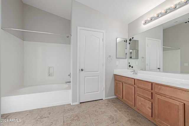 bathroom with shower / tub combination, vanity, and vaulted ceiling