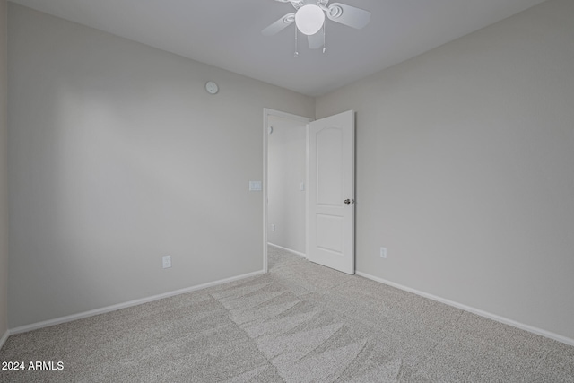 spare room with light carpet and ceiling fan