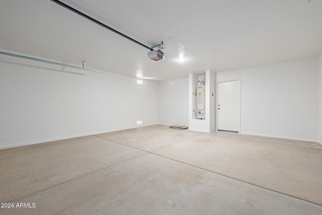 garage featuring gas water heater and a garage door opener