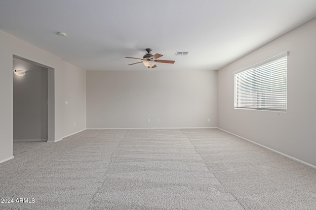 spare room featuring ceiling fan and light colored carpet