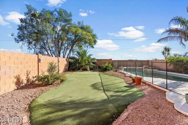 view of yard featuring a fenced in pool