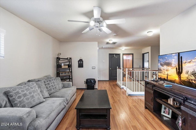 living room featuring light wood-type flooring and ceiling fan