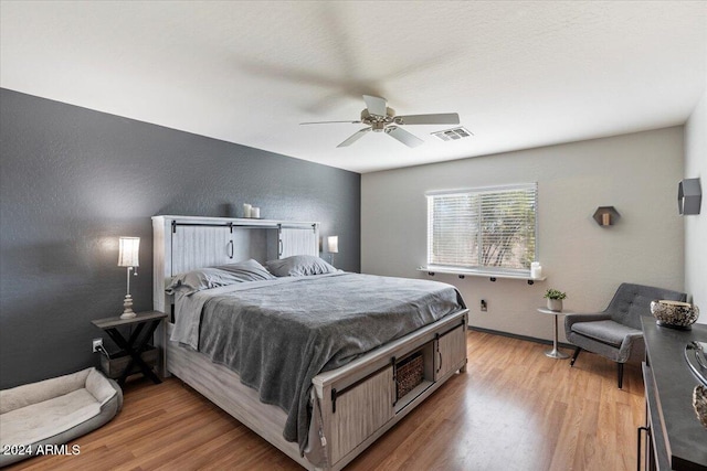 bedroom featuring ceiling fan and light hardwood / wood-style flooring