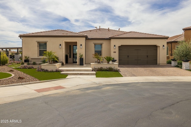 351 E Santa Lucia Ln, Queen Creek, AZ 85140 - view of front of home featuring driveway, an attached garage, a tiled roof, and stucco siding