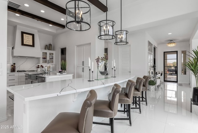 351 E Santa Lucia Ln, Queen Creek, AZ 85140 - kitchen with a spacious island, a chandelier, backsplash, beamed ceiling, and visible vents