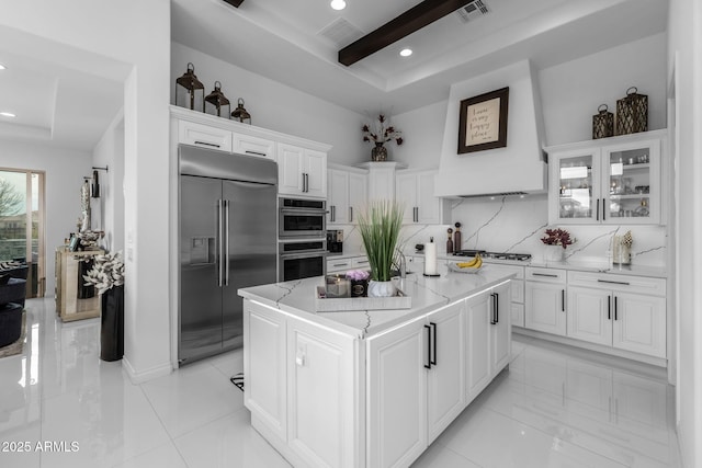 351 E Santa Lucia Ln, Queen Creek, AZ 85140 - kitchen with white cabinetry, tasteful backsplash, stainless steel appliances, visible vents, and custom exhaust hood