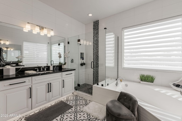 351 E Santa Lucia Ln, Queen Creek, AZ 85140 - bathroom with a stall shower, tile walls, vanity, and a bath