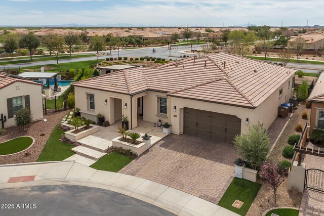 351 E Santa Lucia Ln, Queen Creek, AZ 85140 - mediterranean / spanish house featuring fence, a tile roof, stucco siding, and a garage