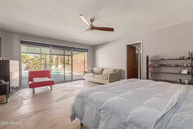 bedroom featuring access to exterior, a ceiling fan, and concrete flooring