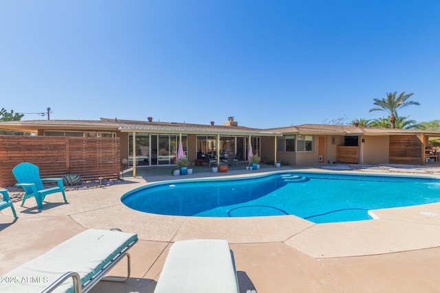 view of pool featuring a patio area, fence, and a fenced in pool