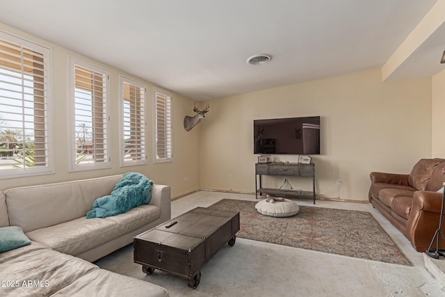 living room with visible vents and baseboards