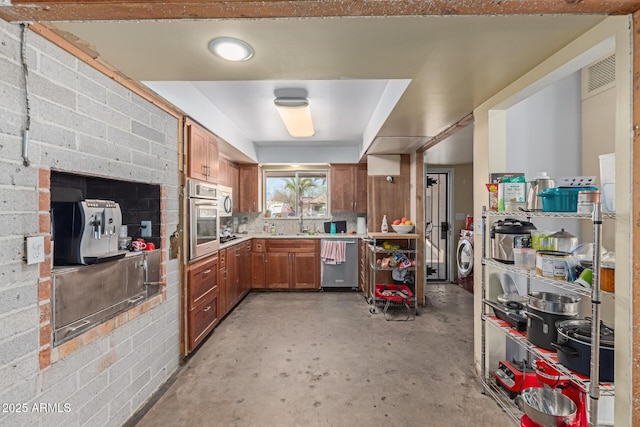 kitchen with visible vents, unfinished concrete floors, brown cabinets, stainless steel appliances, and light countertops