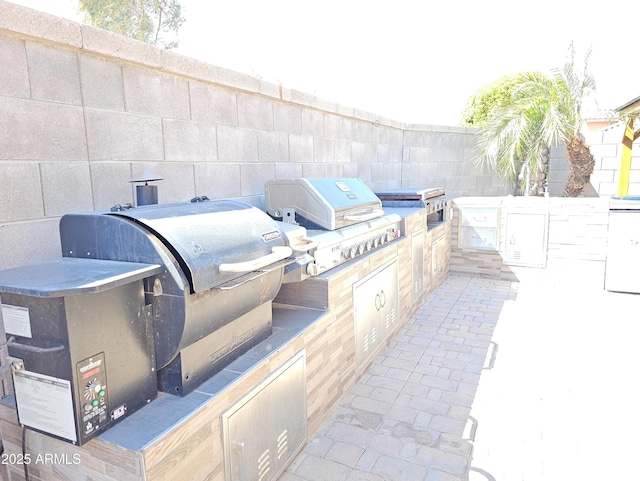2678 S 172nd Dr, Goodyear, AZ 85338 - view of patio / terrace with exterior kitchen, area for grilling, and fence