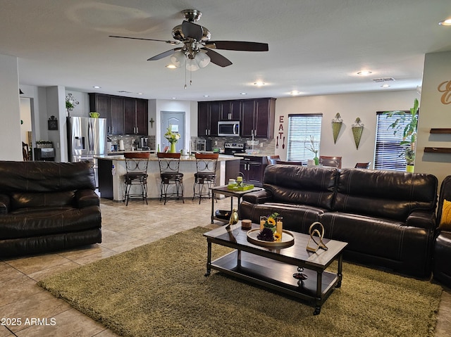 living area with recessed lighting, visible vents, ceiling fan, and light tile patterned floors