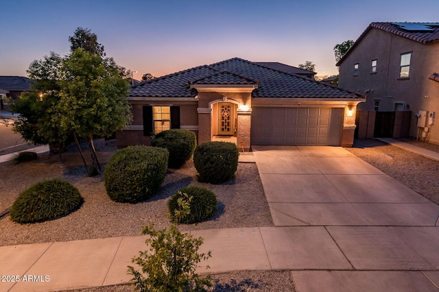 2678 S 172nd Dr, Goodyear, AZ 85338 - mediterranean / spanish home featuring a tile roof, a garage, concrete driveway, stucco siding, and fence