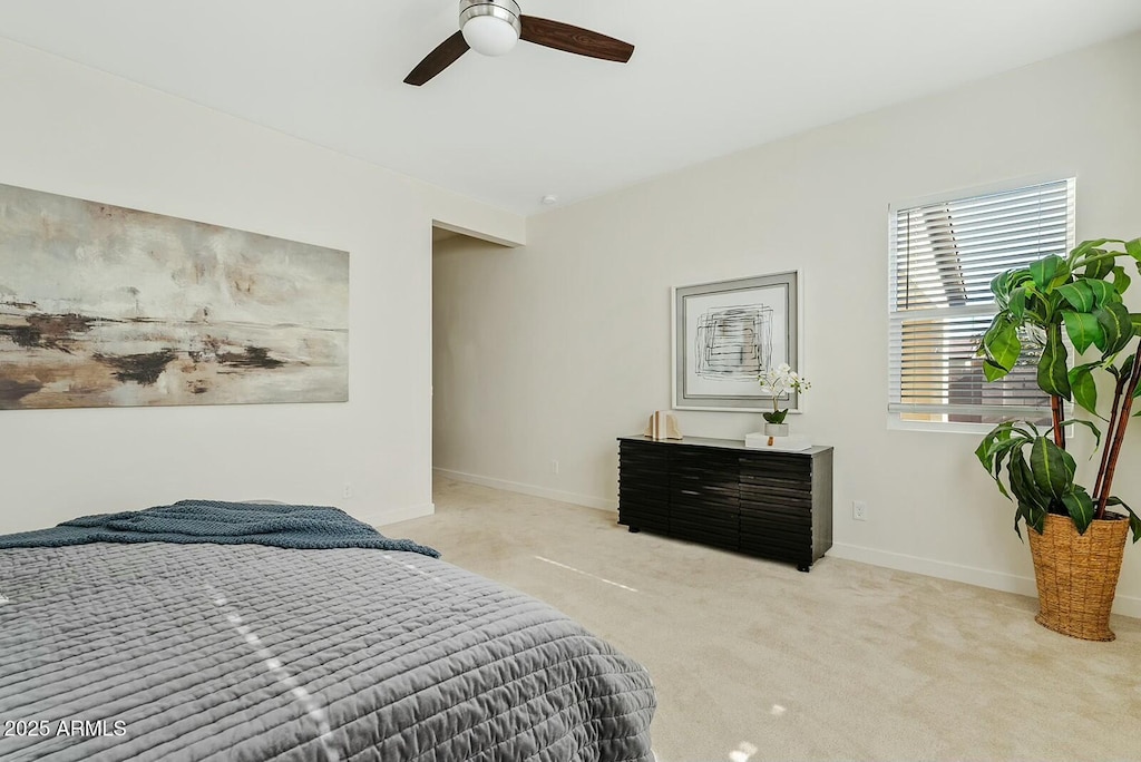 bedroom featuring light colored carpet and ceiling fan