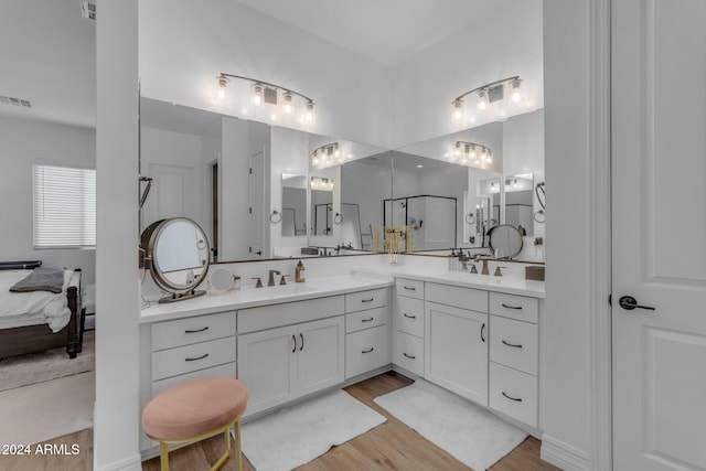 bathroom with hardwood / wood-style floors and vanity