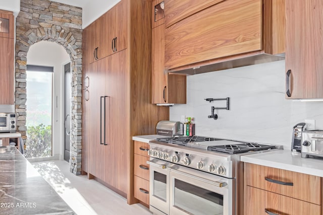 kitchen featuring light countertops, modern cabinets, and double oven range