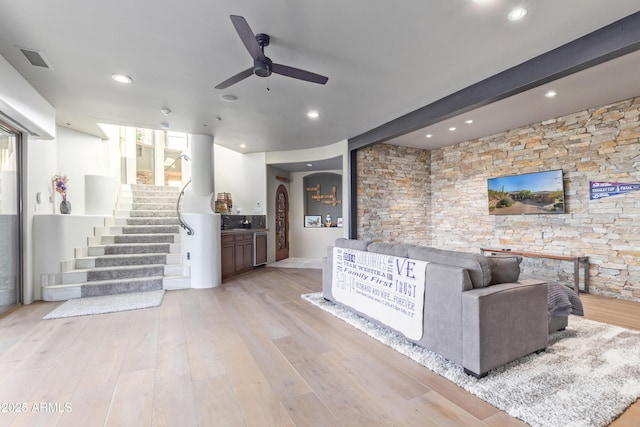 welcome area with stairs, ceiling fan, and visible vents