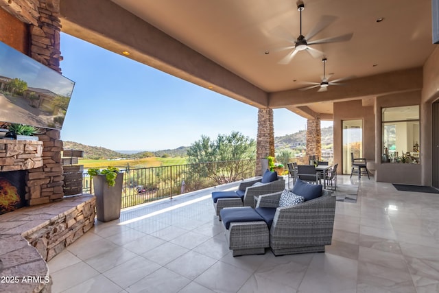 view of patio with outdoor dining space and ceiling fan