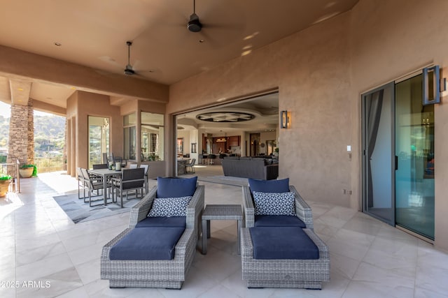 view of patio / terrace with outdoor dining area, ceiling fan, and an outdoor hangout area