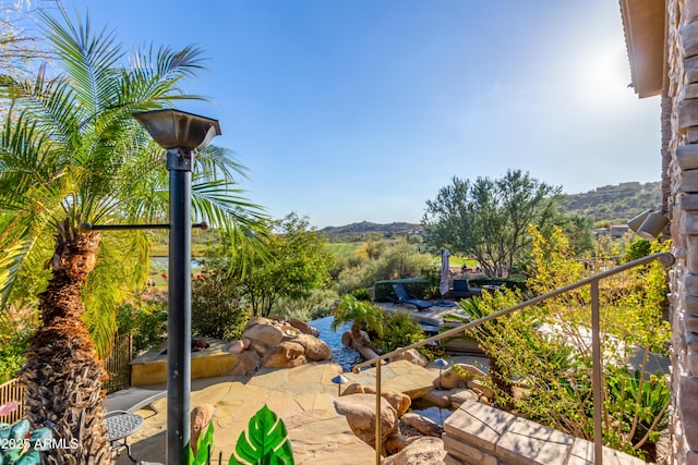 exterior space featuring a mountain view and a patio