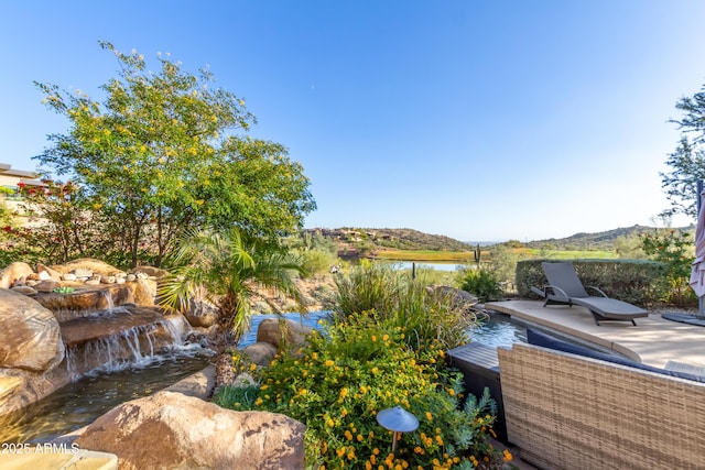 exterior space with a patio and a water view