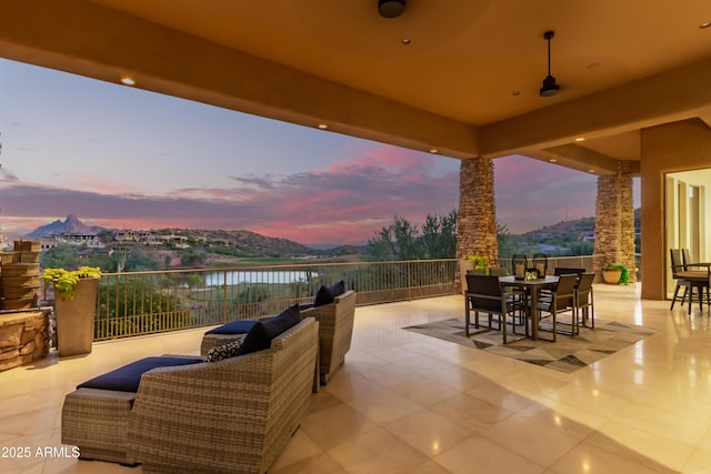 view of patio with a water view and outdoor dining area