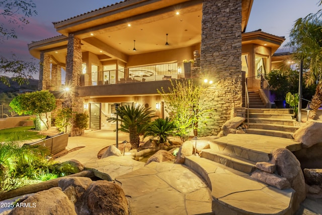 exterior space featuring stairs, a patio area, and a balcony