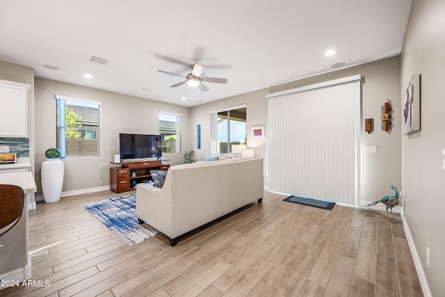 living room featuring ceiling fan and light hardwood / wood-style floors