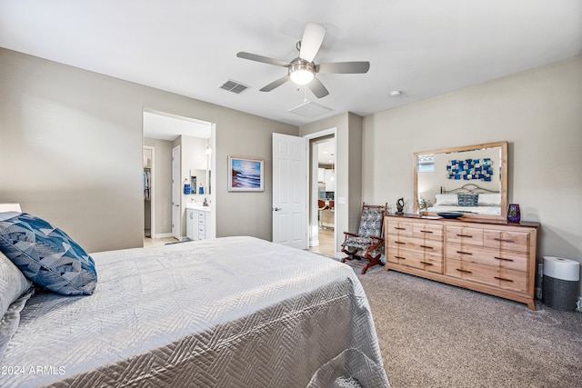 bedroom with ensuite bathroom, carpet, and ceiling fan