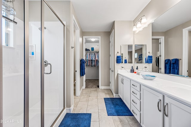 bathroom featuring walk in shower, tile patterned floors, and vanity